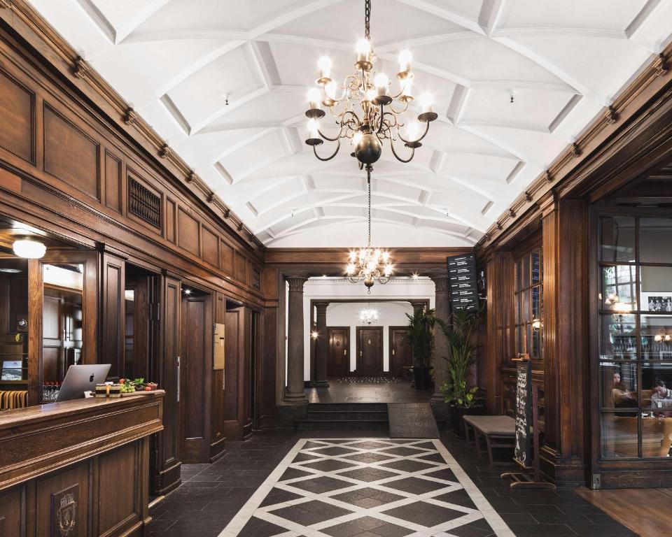Klassieke hotellobby met houten wanden en kroonluchters