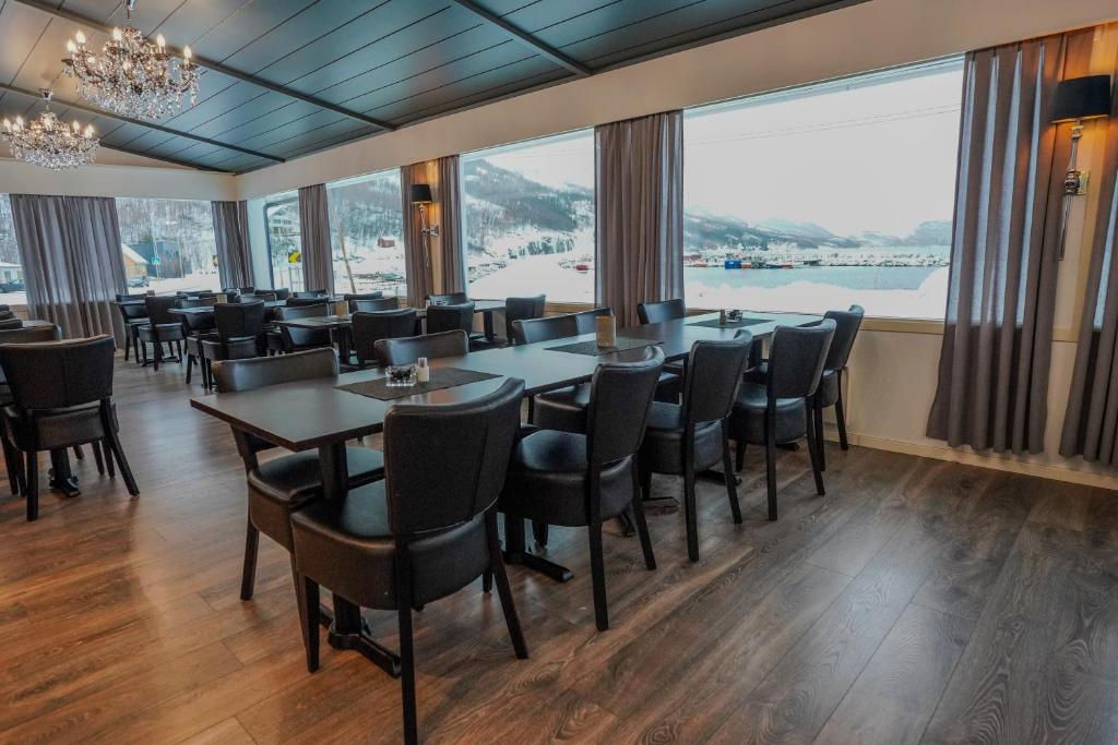 Hotelrestaurant met gedekte tafels en grote ramen