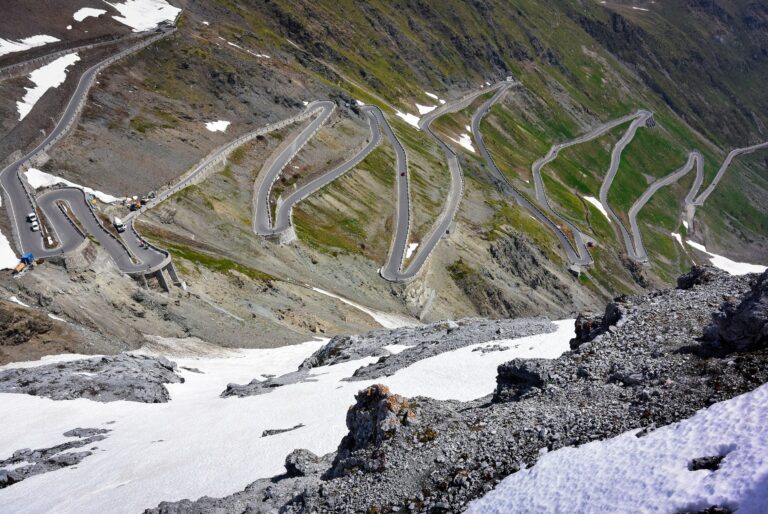 Bochtige bergweg met opeenvolgende haarspeldbochten tegen een steile helling